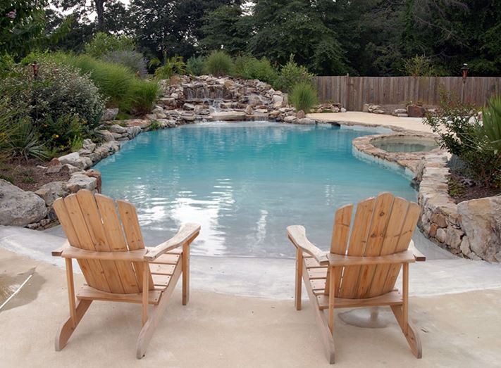 beach entry pool with 2 Adirondack chairs