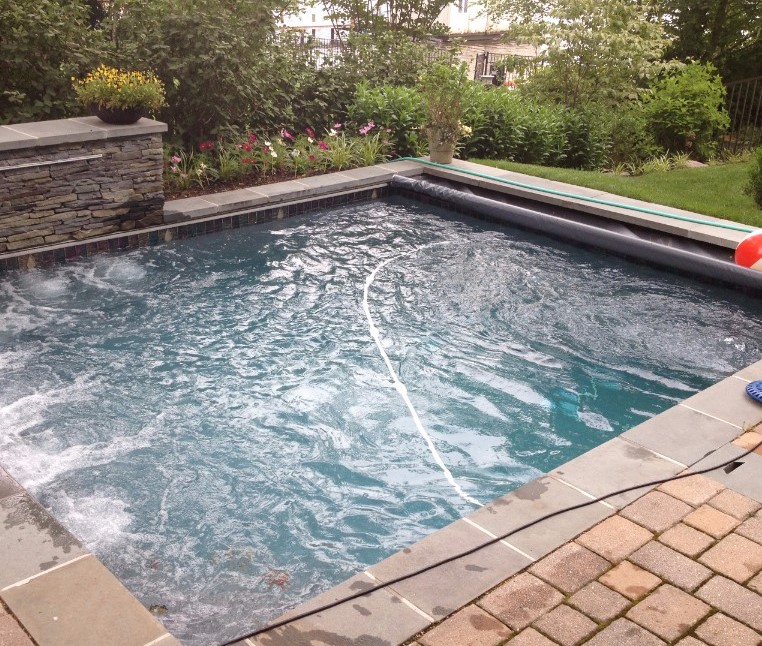 Professional custom-built spa in backyard